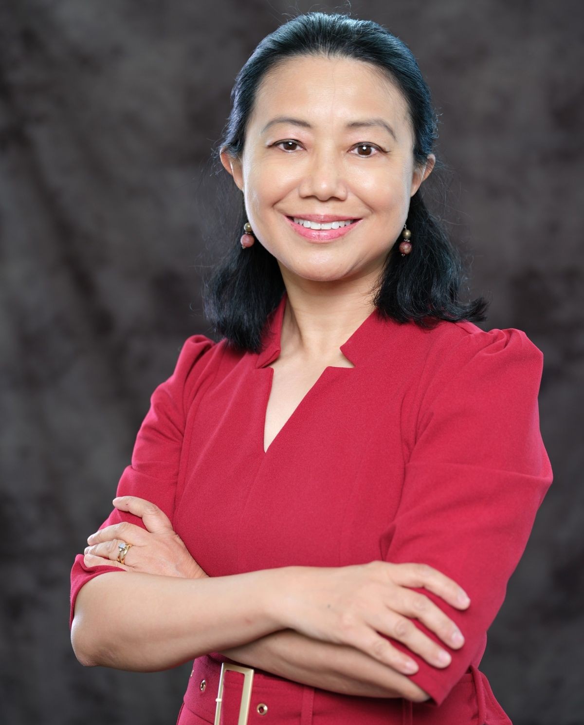 Michelle Chen, Ph.D. in a studio portrait wearing a red outfit