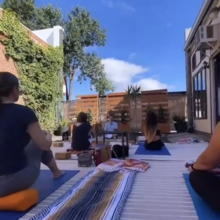 Jason Jurado leading a meditation gathering outdoors with participants