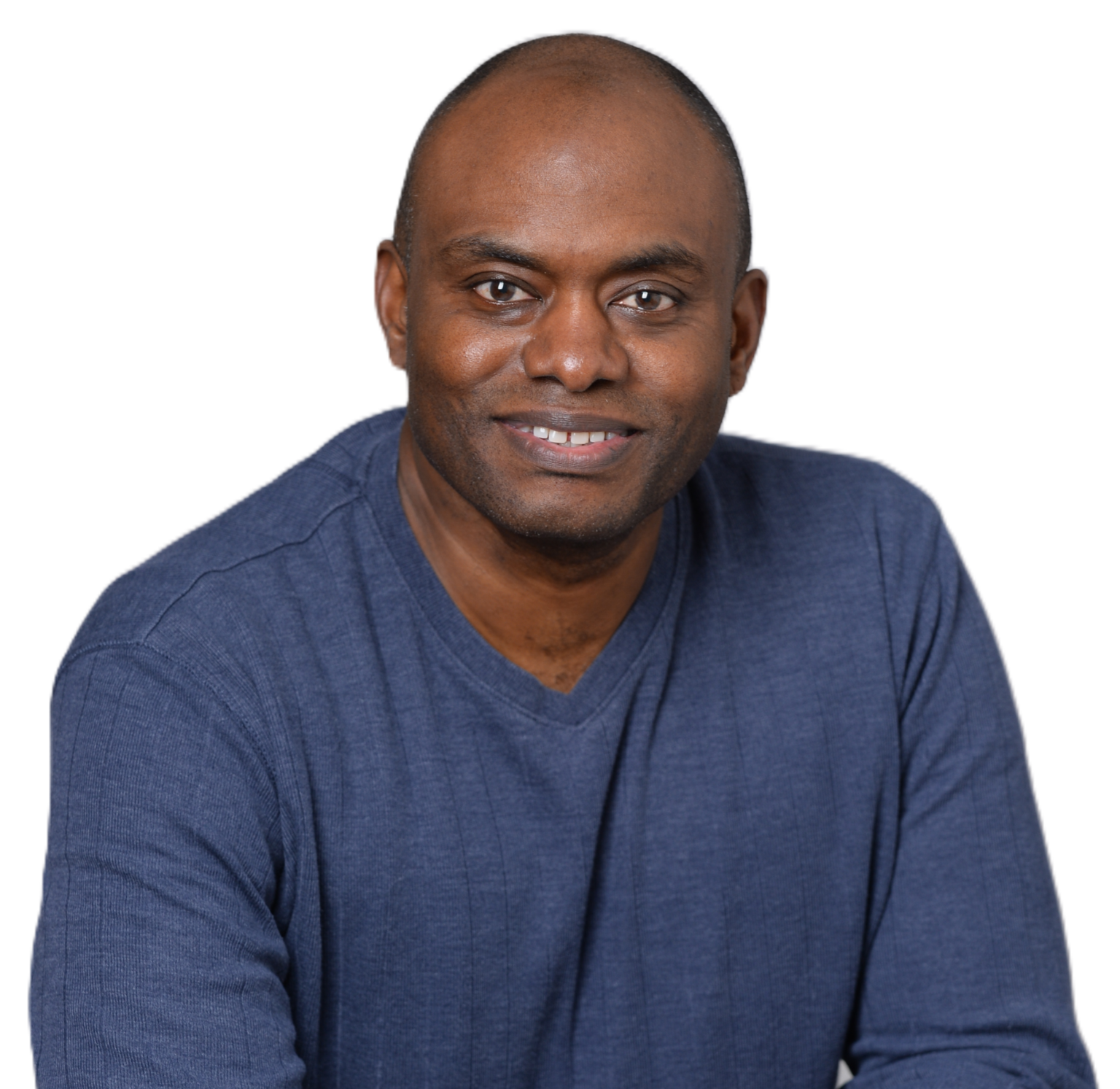 Darren Mann smiling in a blue V-neck sweater against a white background